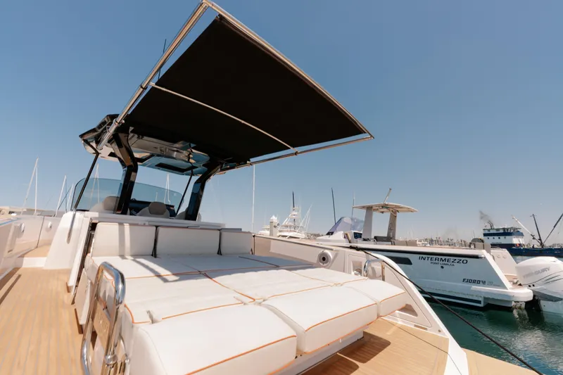 Slide: The Image of 2022 Pardo Yachts 38 with sunshade, docked at marina under clear blue sky. - 39
