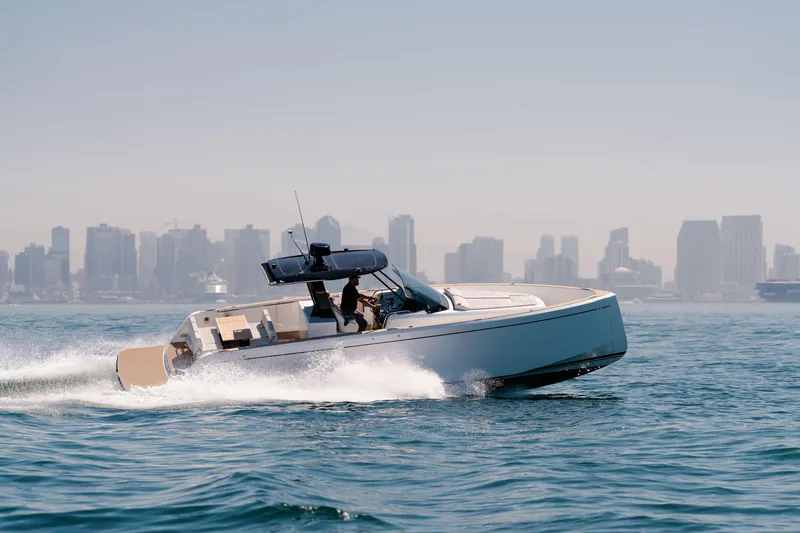 Slide: The Image of 2022 Pardo Yachts 38 cruising on water with city skyline in background. - 41