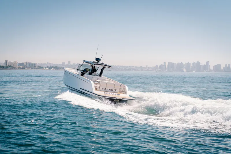 Slide: The Image of 2022 Pardo Yachts 38 cruising on open water with city skyline in background. - 43