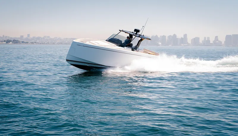 Slide: The Image of 2022 Pardo Yachts 38 cruising on open water with city skyline in background. - 44