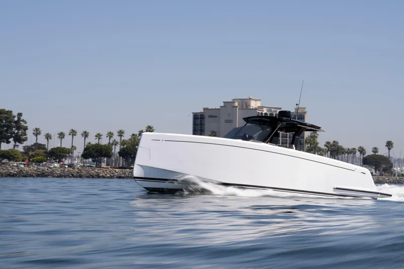 Slide: The Image of 2022 Pardo Yachts 38 cruising on calm waters near a coastal cityscape. - 45