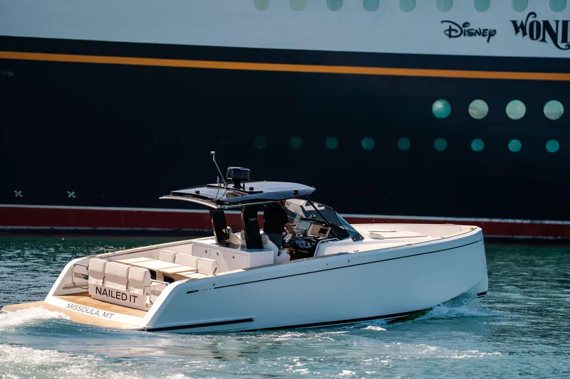 Slide: The Image of 2022 Pardo Yachts 38 cruising near a large ship, showcasing sleek design and luxury. - 47