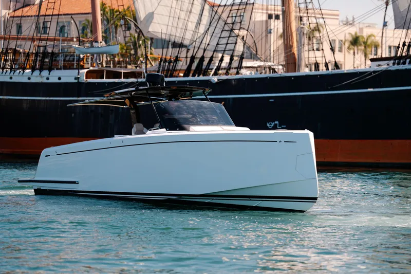 Slide: The Image of 2022 Pardo Yachts 38 cruising in a marina, with historic ships in the background. - 2