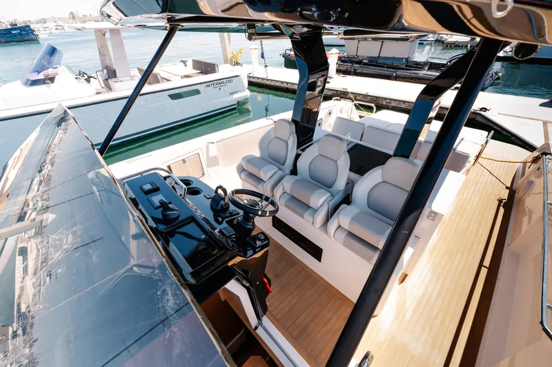 Slide: The Image of 2022 Pardo Yachts 38 interior with sleek helm and luxurious seating. - 24