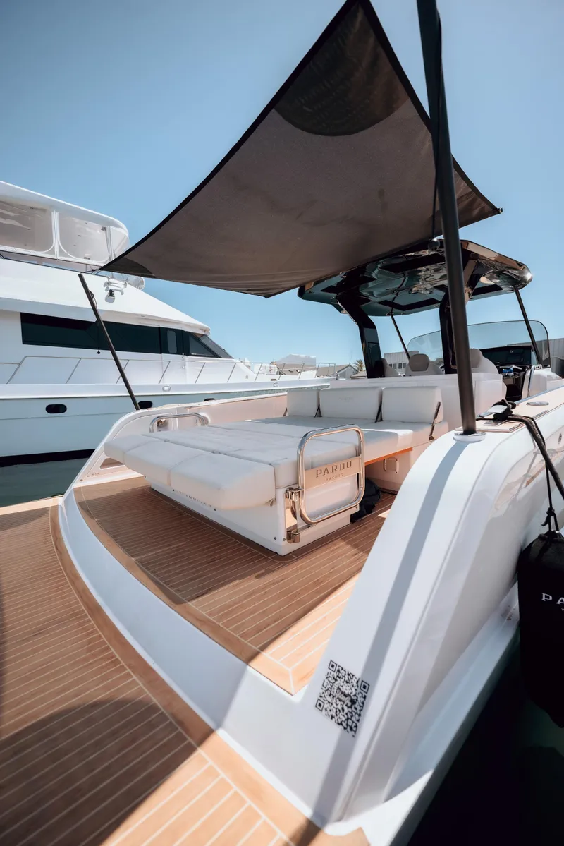 Slide: The Image of 2022 Pardo Yachts 38 with sunshade, docked, showcasing luxurious deck seating. - 27