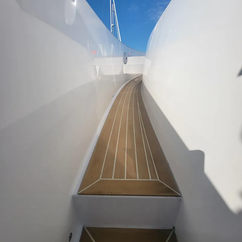 Slide: The Image of Side deck of 2022 Pardo Yachts 38, featuring sleek wooden flooring and white hull. - 31