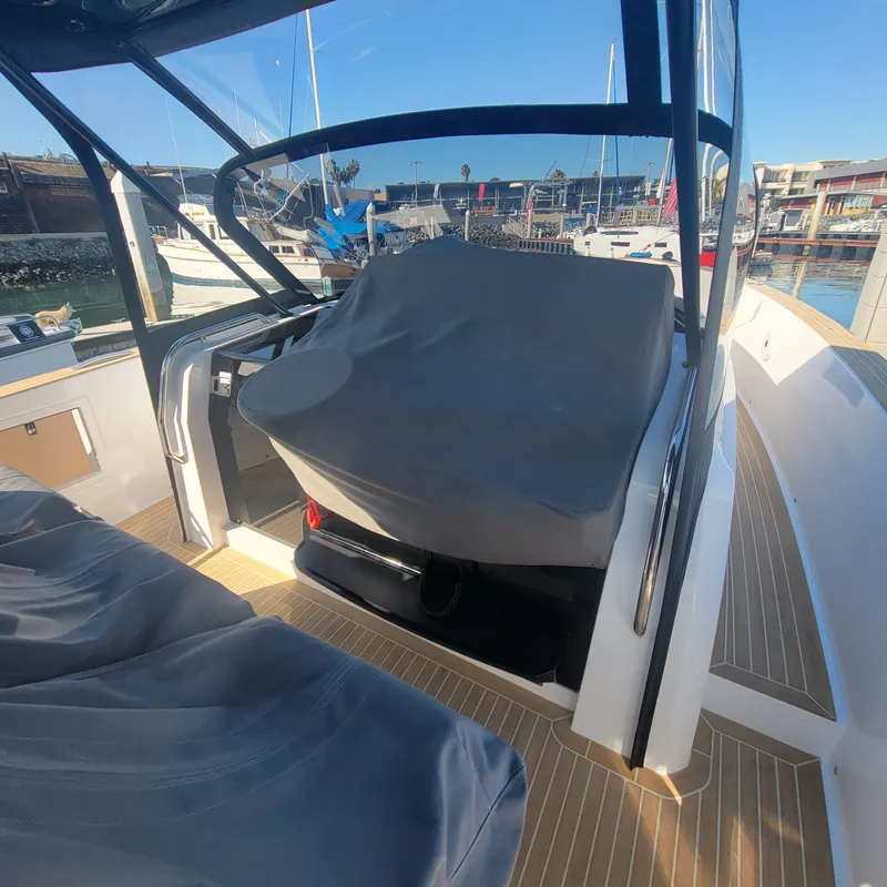 Slide: The Image of 2022 Pardo Yachts 38 helm station covered, docked in a marina. - 32