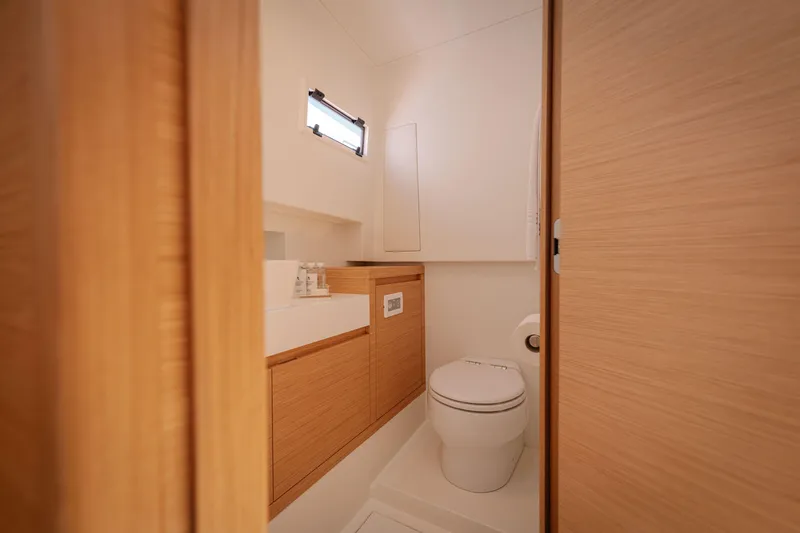 Slide: The Image of Modern bathroom interior on 2022 Pardo Yachts 38, featuring sleek wood cabinetry and compact design. - 36