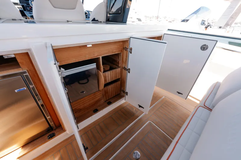 Slide: The Image of 2022 Pardo Yachts 38 interior storage with open cabinets and wood finish. - 38