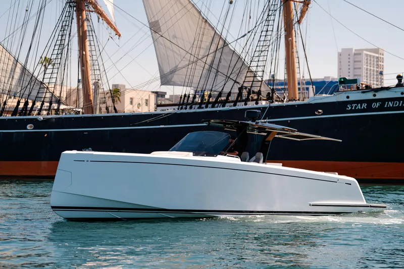 Slide: The Image of 2022 Pardo Yachts 38 cruising near a historic sailing ship in a harbor. - 4