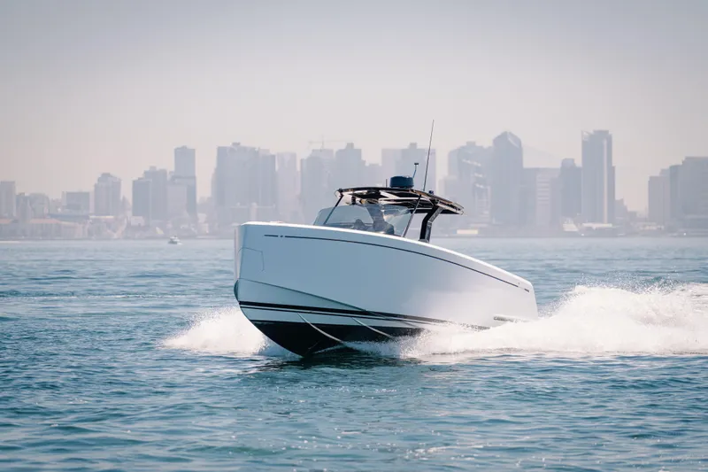 Slide: The Image of 2022 Pardo Yachts 38 cruising on water with city skyline in background. - 42