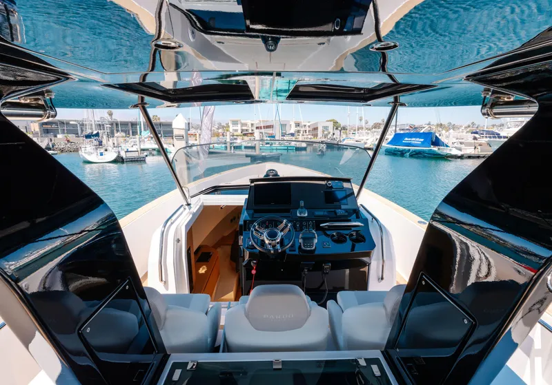 Slide: The Image of Pardo Yachts 38, 2022 model, luxury helm view with marina backdrop. - 5