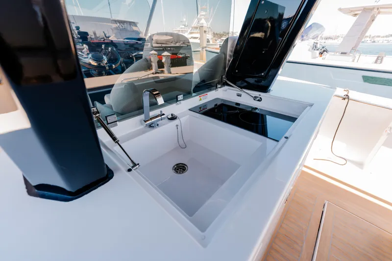 Slide: The Image of Modern kitchen area on 2022 Pardo Yachts 38, featuring sink and stove. - 8