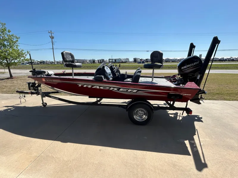 Slide: The Image of 2018 Tracker 175TWX boat with Mercury engine on trailer, parked outdoors. - 5