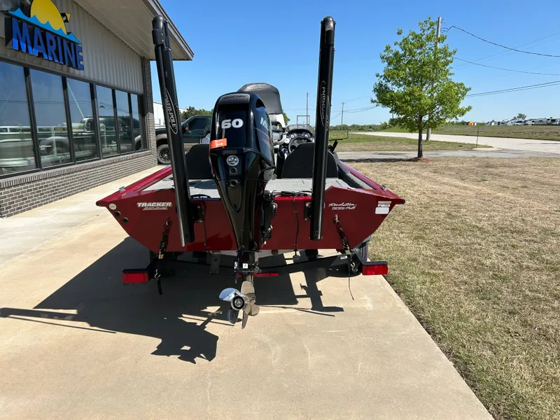 Slide: The Image of 2018 Tracker 175TWX boat with 150HP engine, parked outside a marine dealership. - 6