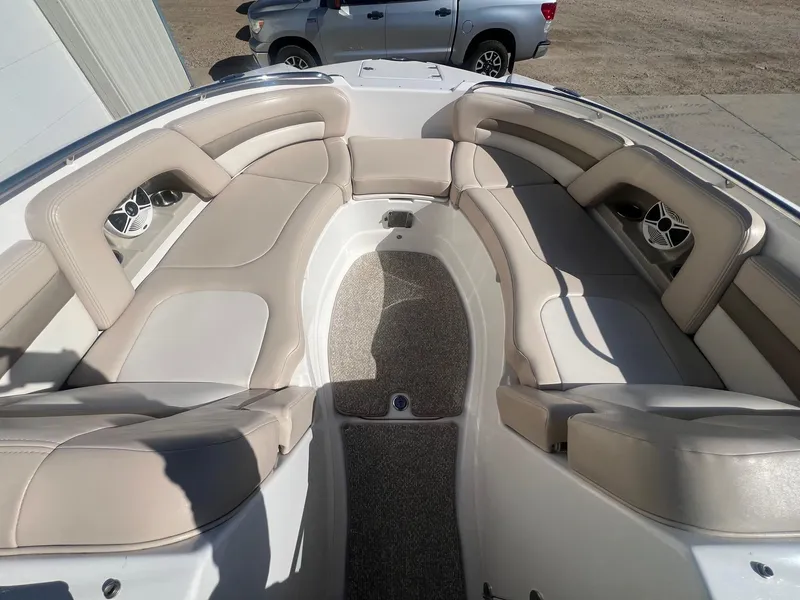 Slide: The Image of 2011 Chaparral 264 Sunesta boat interior with beige seating and carpeted floor. - 11