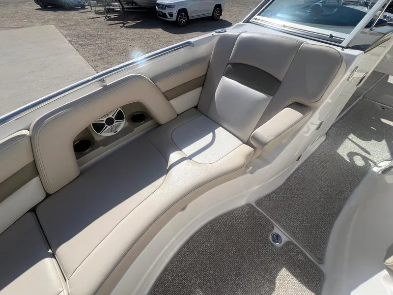 Slide: The Image of 2011 Chaparral 264 Sunesta boat interior with beige seating and speaker system. - 13