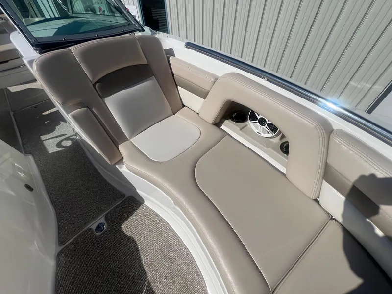 Slide: The Image of 2011 Chaparral 264 Sunesta boat interior with beige seating and speaker system. - 15