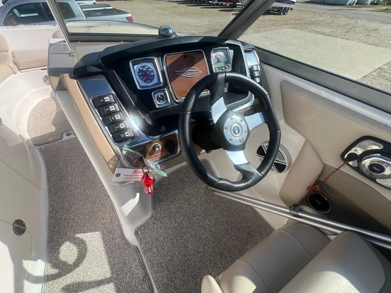 Slide: The Image of 2011 Chaparral 264 Sunesta boat dashboard with steering wheel and control panel. - 18