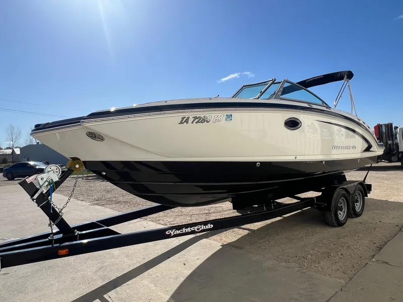 Slide: The Image of 2011 Chaparral 264 Sunesta boat on trailer under clear blue sky. - 2
