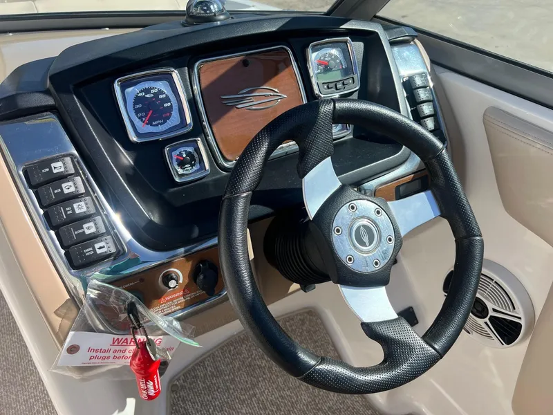 Slide: The Image of 2011 Chaparral 264 Sunesta dashboard with steering wheel and control panel. - 21
