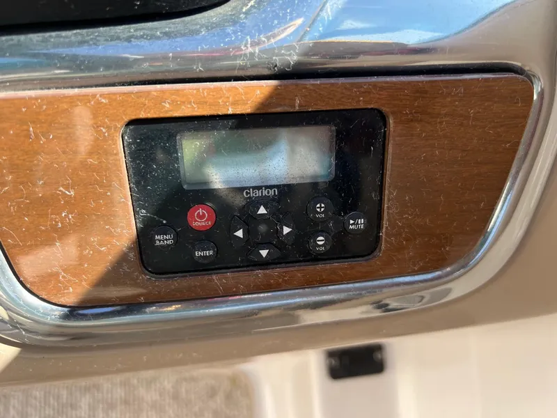 Slide: The Image of Control panel of a 2011 Chaparral 264 Sunesta boat with Clarion audio system. - 22
