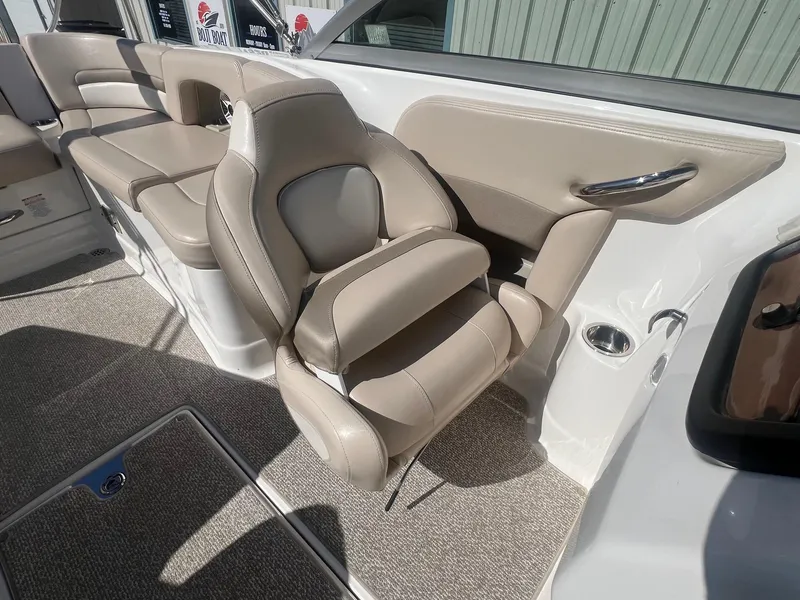 Slide: The Image of 2011 Chaparral 264 Sunesta boat interior with beige seating and carpeted flooring. - 24