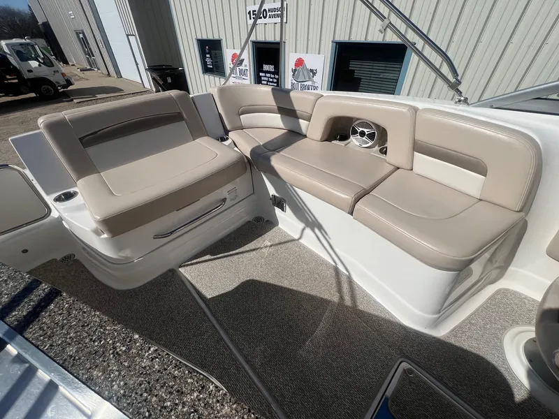 Slide: The Image of 2011 Chaparral 264 Sunesta boat interior with beige seating and speaker. - 26