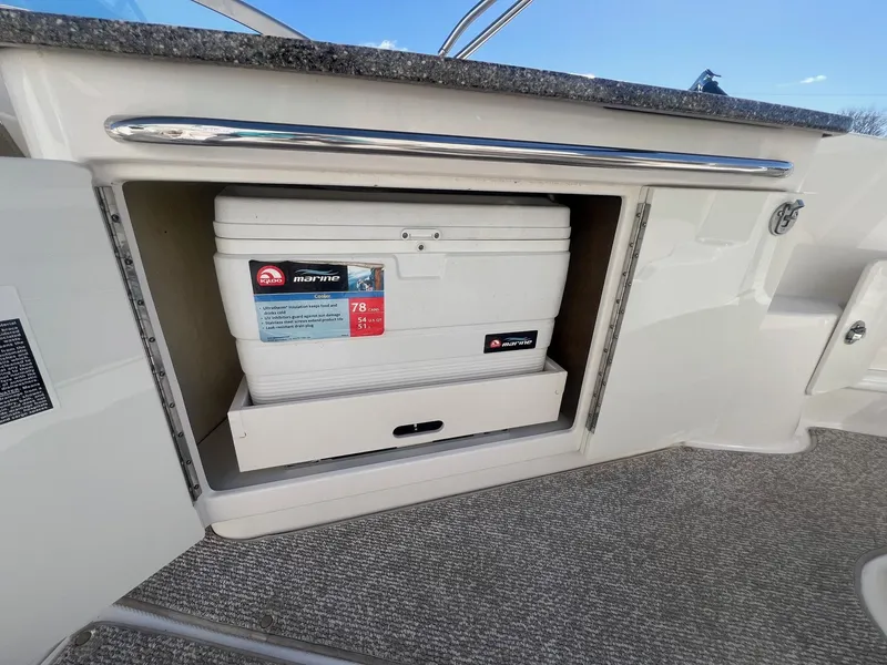 Slide: The Image of 2011 Chaparral 264 Sunesta boat with built-in cooler storage compartment. - 32