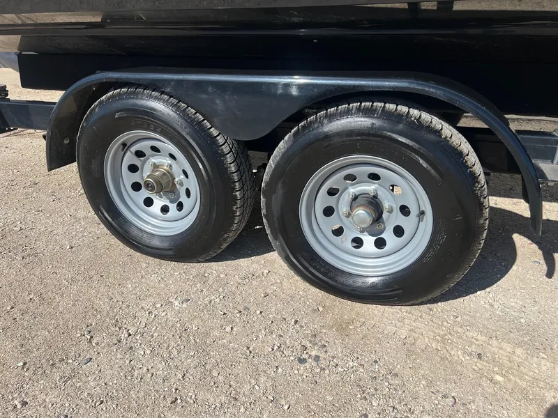 Slide: The Image of Trailer wheels of a 2011 Chaparral 264 Sunesta on a gravel surface. - 36