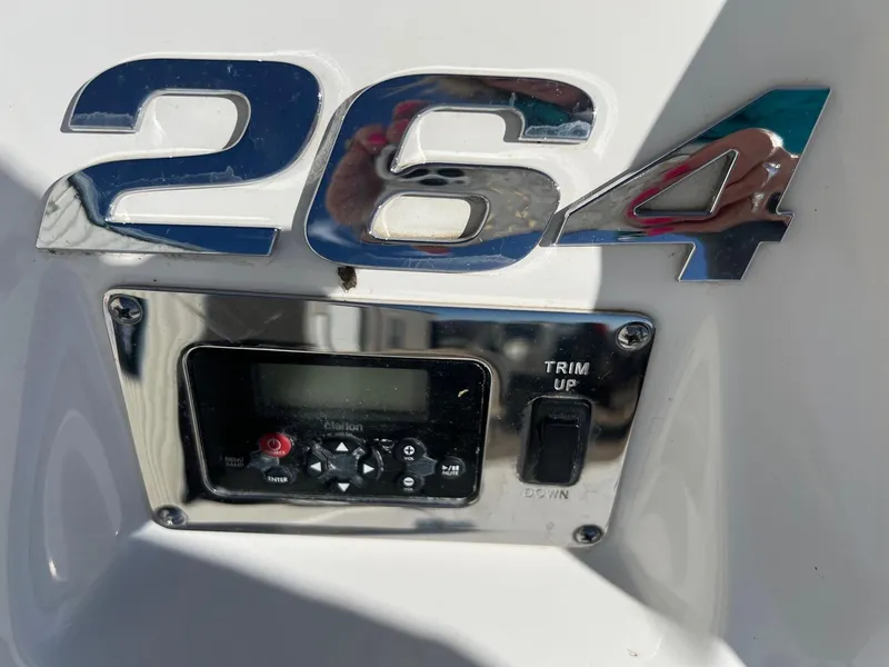 Slide: The Image of 2011 Chaparral 264 Sunesta boat control panel with trim switch and display. - 6