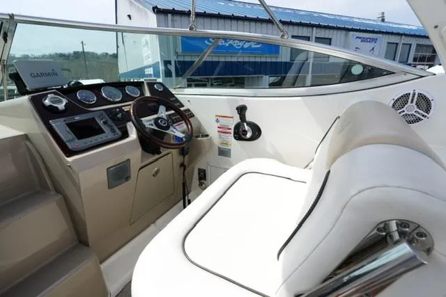 Slide: The Image of 2009 Sea Ray 270 Sundancer cockpit with steering wheel and control panel. - 10