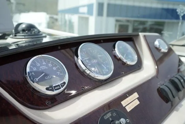Slide: The Image of Dashboard of 2009 Sea Ray 270 Sundancer boat with gauges and controls. - 12