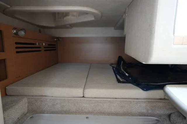 Slide: The Image of Interior cabin of 2009 Sea Ray 270 Sundancer, featuring a compact sleeping area. - 16
