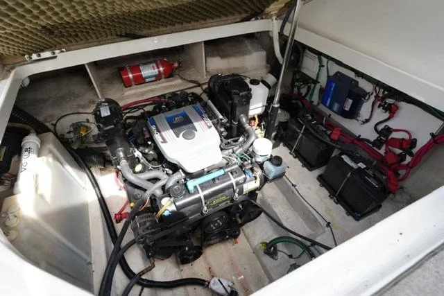 Slide: The Image of Engine compartment of a 2009 Sea Ray 270 Sundancer boat, featuring a well-maintained motor. - 18