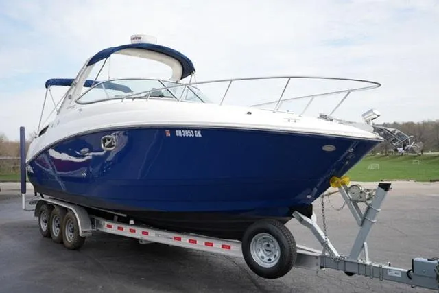 Slide: The Image of 2009 Sea Ray 270 Sundancer boat on a trailer, featuring a sleek blue and white design. - 3