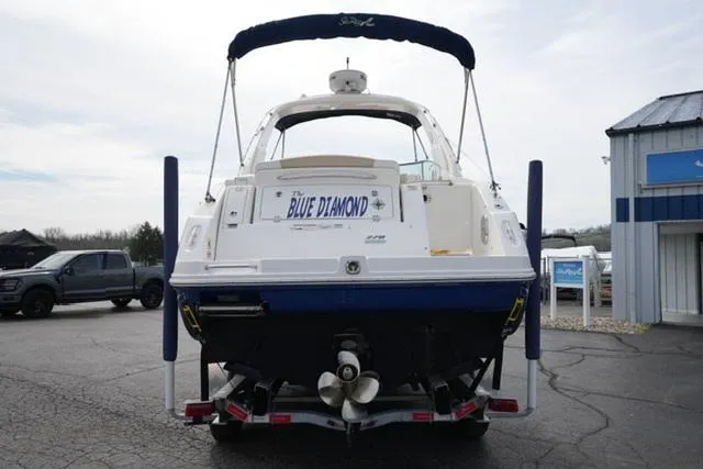 Slide: The Image of 2009 Sea Ray 270 Sundancer boat, named "Blue Diamond," on a trailer in a parking lot. - 6
