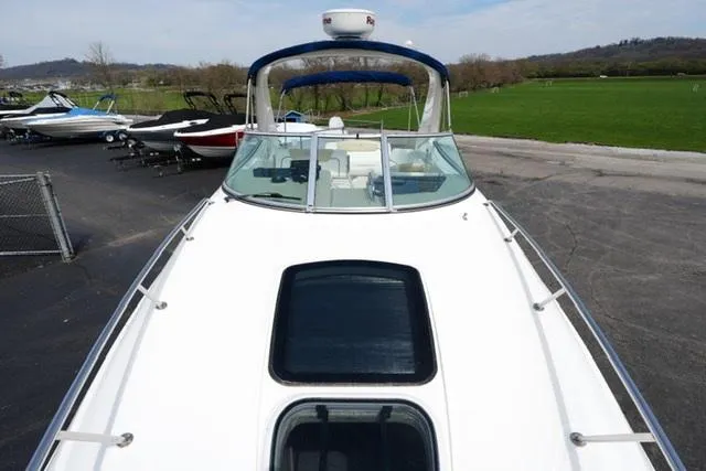 Slide: The Image of 2009 Sea Ray 270 Sundancer boat on display in a marina setting. - 8