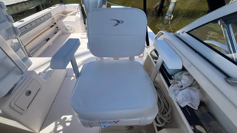 Slide: The Image of 2005 Grady-White Seafarer 226 boat interior with cushioned seating and armrests. - 11