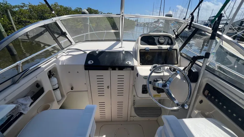 Slide: The Image of 2005 Grady-White Seafarer 226 boat cockpit with steering wheel and control panel. - 12
