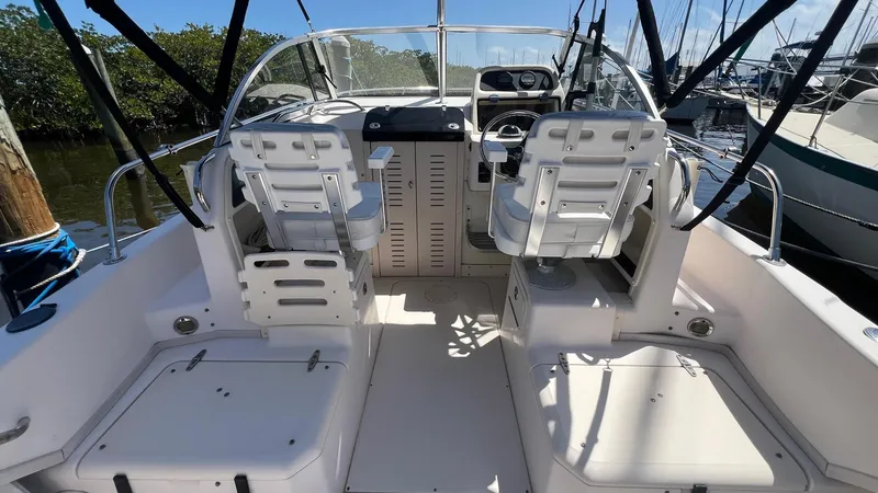 Slide: The Image of 2005 Grady-White Seafarer 226 boat interior with dual captain chairs and control panel. - 13