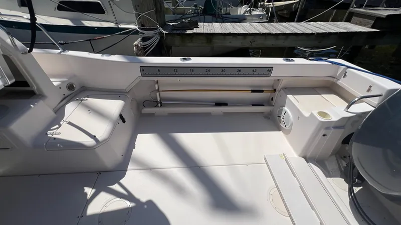 Slide: The Image of 2005 Grady-White Seafarer 226 boat interior, featuring spacious deck and fishing rod storage. - 15
