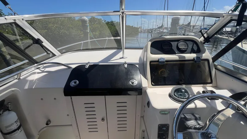 Slide: The Image of 2005 Grady-White Seafarer 226 boat dashboard with steering wheel and navigation instruments. - 20