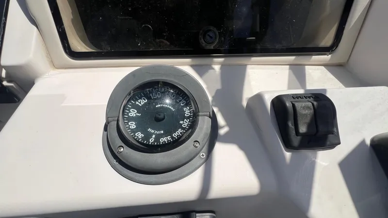 Slide: The Image of Compass and control panel on 2005 Grady-White Seafarer 226 boat. - 21
