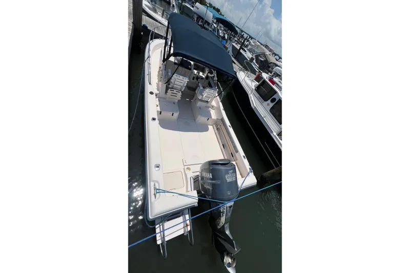 Slide: The Image of 2005 Grady-White Seafarer 226 boat docked, featuring a Yamaha outboard motor and blue canopy. - 4