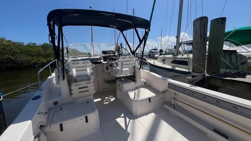 Slide: The Image of 2005 Grady-White Seafarer 226 boat interior with seating and canopy, docked at marina. - 5