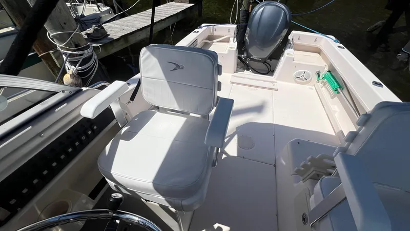 Slide: The Image of 2005 Grady-White Seafarer 226 boat interior with seating and motor, docked at marina. - 8