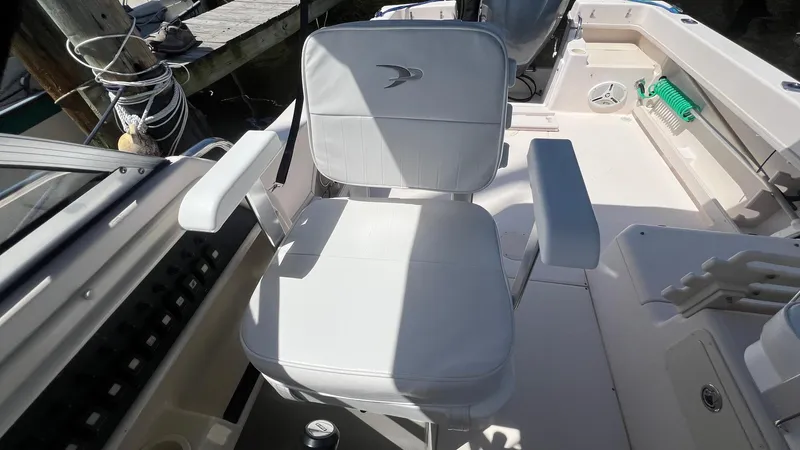 Slide: The Image of Captain's chair on 2005 Grady-White Seafarer 226 boat, docked with visible deck details. - 9