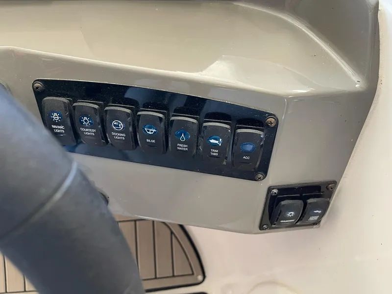 Slide: The Image of Control panel of 2022 Stingray 231 DC boat with labeled switches. - 16