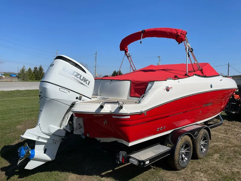 Slide: The Image of 2022 Stingray 231 DC boat with Suzuki outboard motor on a trailer. - 4